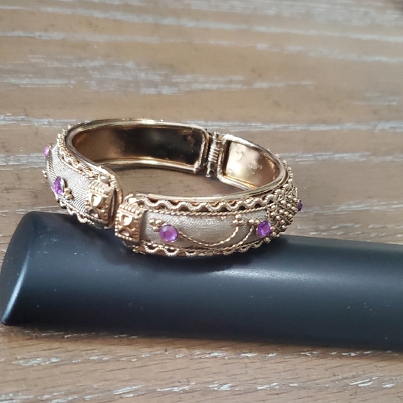 Gold tone Intricate bracelet w/ raised pattern with amethyst cor stones on Hinge - Picture 1 of 5